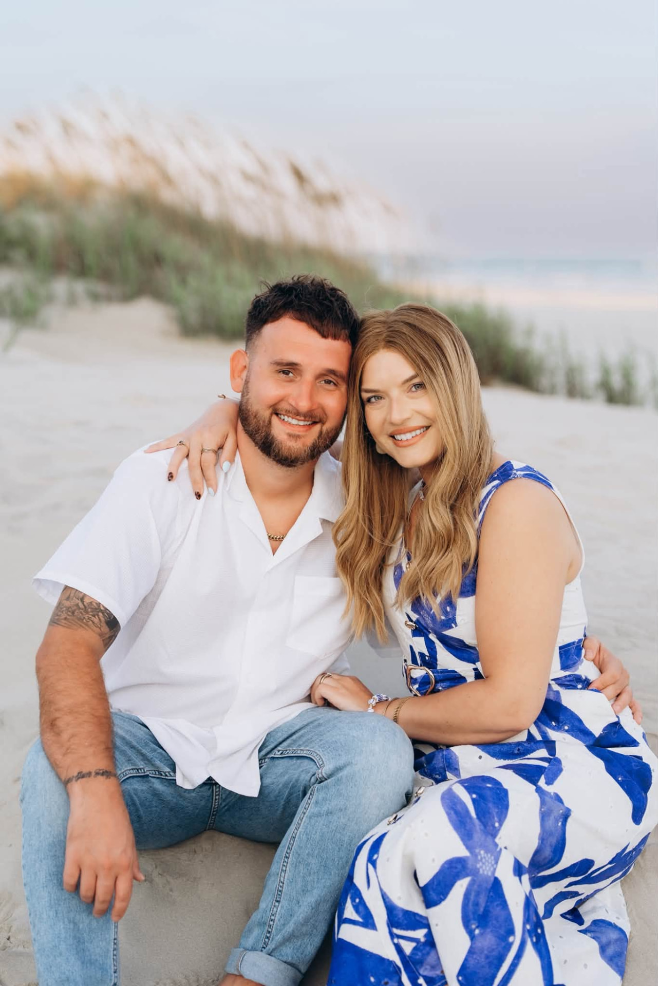 Kristin and her husband on the beach at sunset