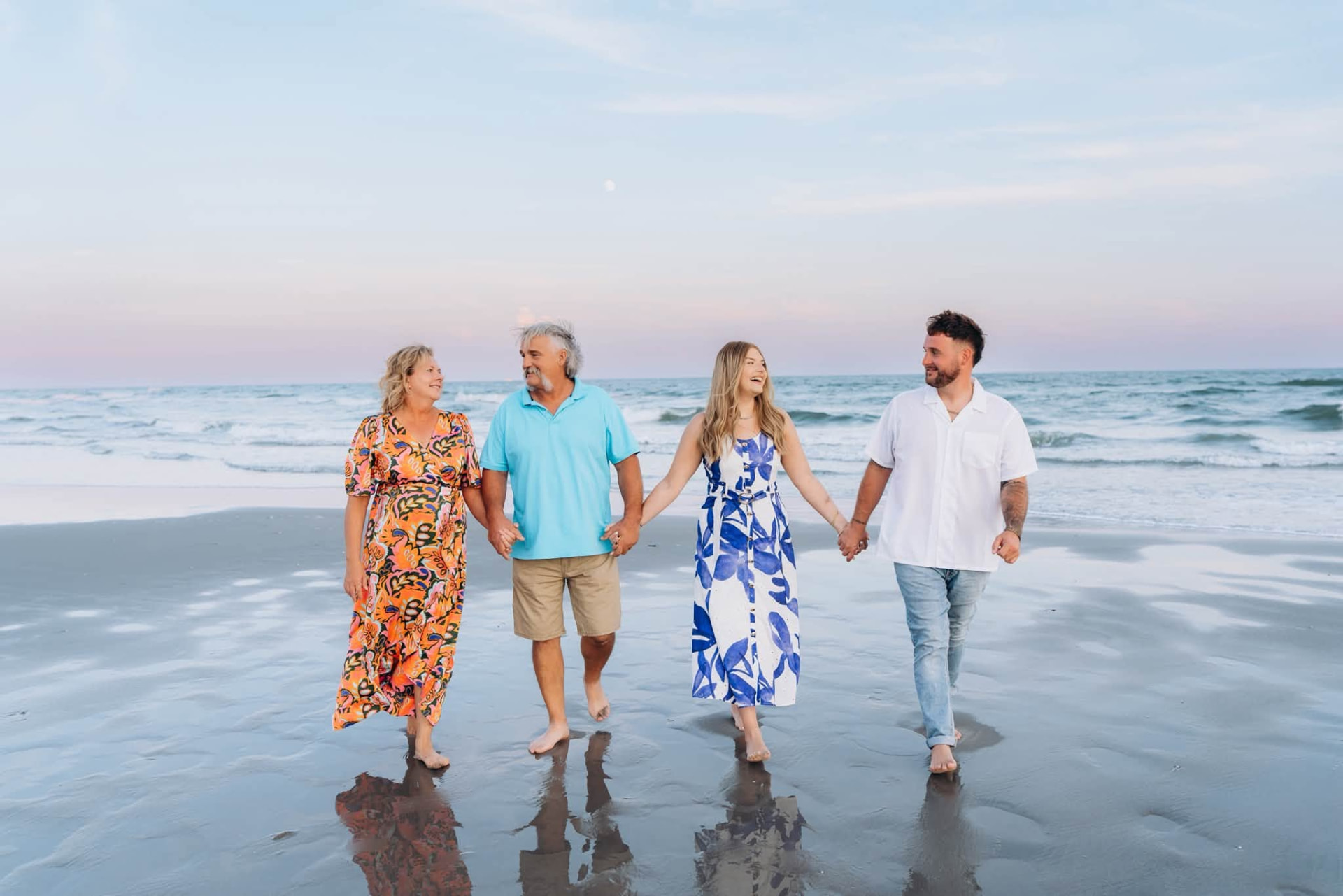 Kristin walking hand in hand with her family along the shore